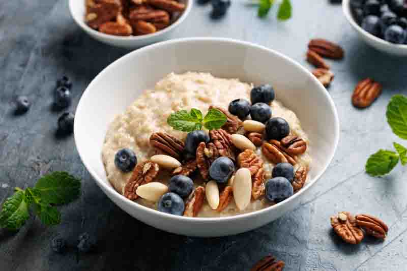 Oatmeal porridge with blueberry, almonds, and pecan healthy food breakfast.
