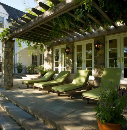 Garden ideas, Landscaping Ideas, arbor, pergola, french doors,green,lanterns,lounge chairs,pergola,posts,potted plants,seat cushions,shady, steps,stone facade, stone floor, stone walls,vines,walls sconce,white painted trim,wisteria
