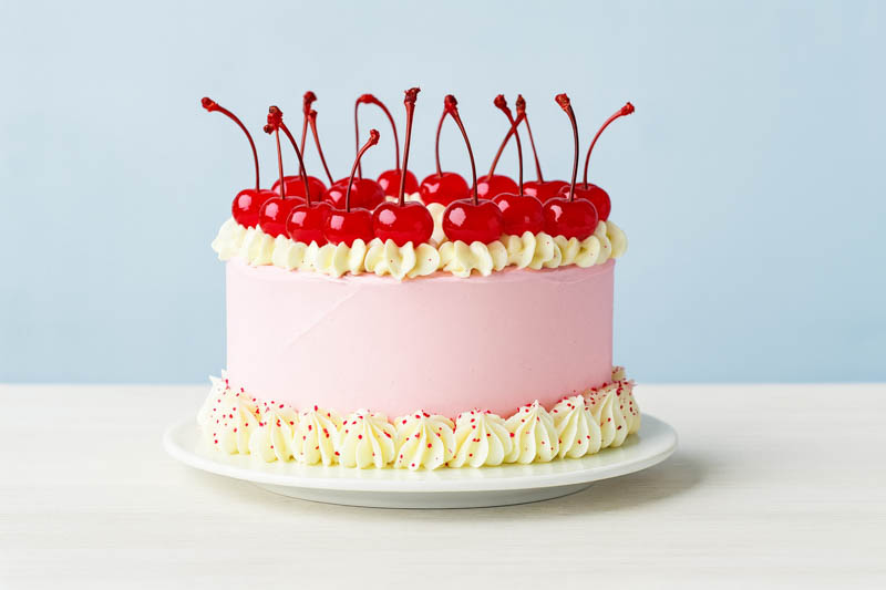 Cake decorated with homemade Maraschino cherries and syrup