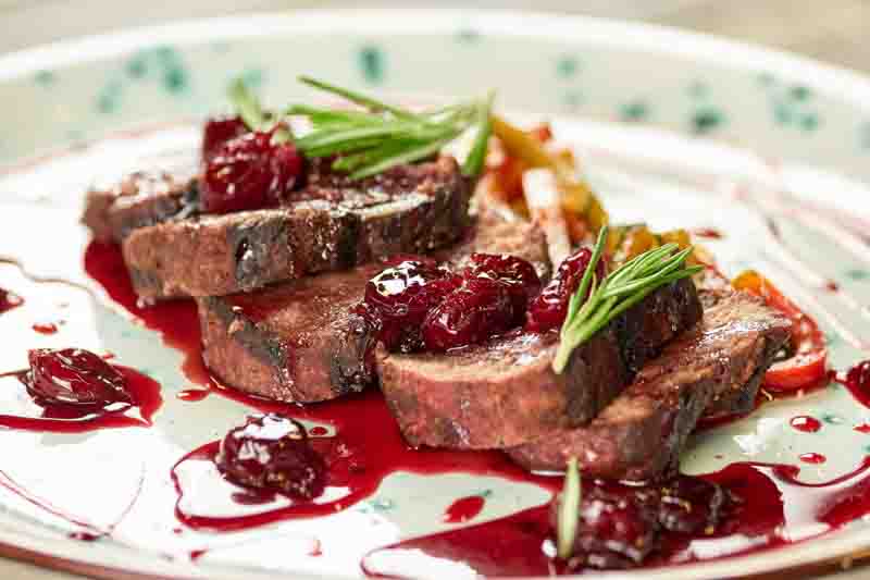 Restaurant dish with lamb and side dish, closeup. Served dish with grilled veal and side dish.