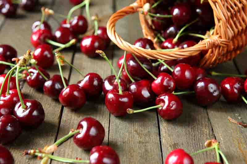 ripe cherry on a wooden table, food close up