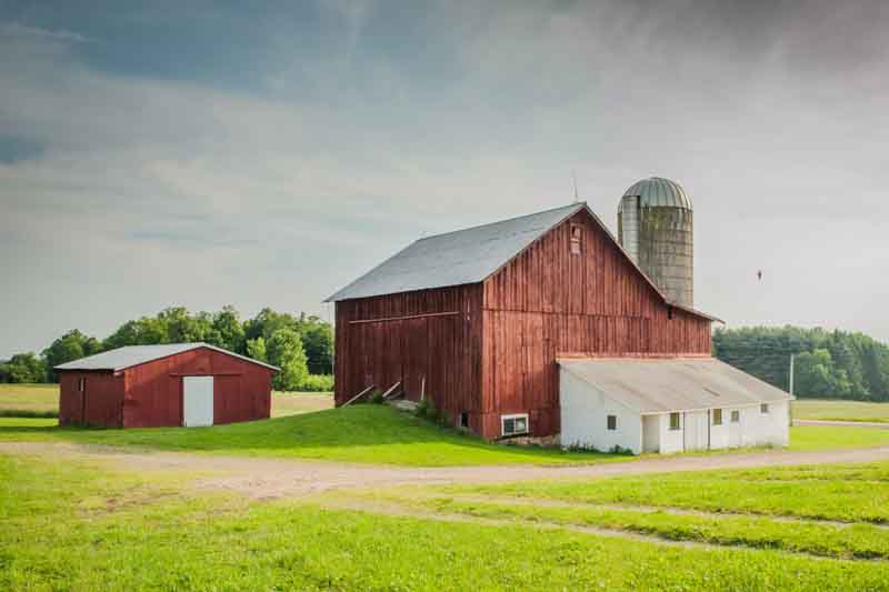 A beautiful old barn with a milkhouse in a field of rural areas of Pennsylvania
