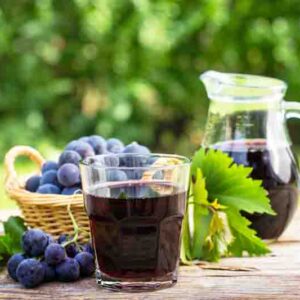 Refreshing grape juice on rustic table