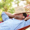 Man Relaxing In Hammock