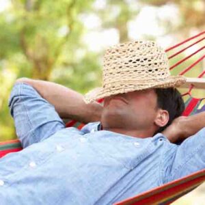 Man Relaxing In Hammock