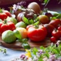 Tomato vegetable - a garden harvest of gourmet varieties of heirloom tomatoes, Solanum lycopersicum - includes black, cherry, plum, oxheart and beefsteak delicious red berries.